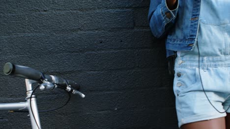 Woman-having-coffee-while-leaning-against-wall-4k