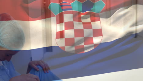 digital composition of croatia flag waving against stressed caucasian female surgeon at hospital