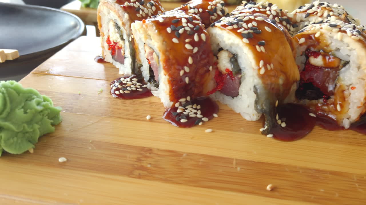 Close up of sushi rolls on wooden trays at a restaurant