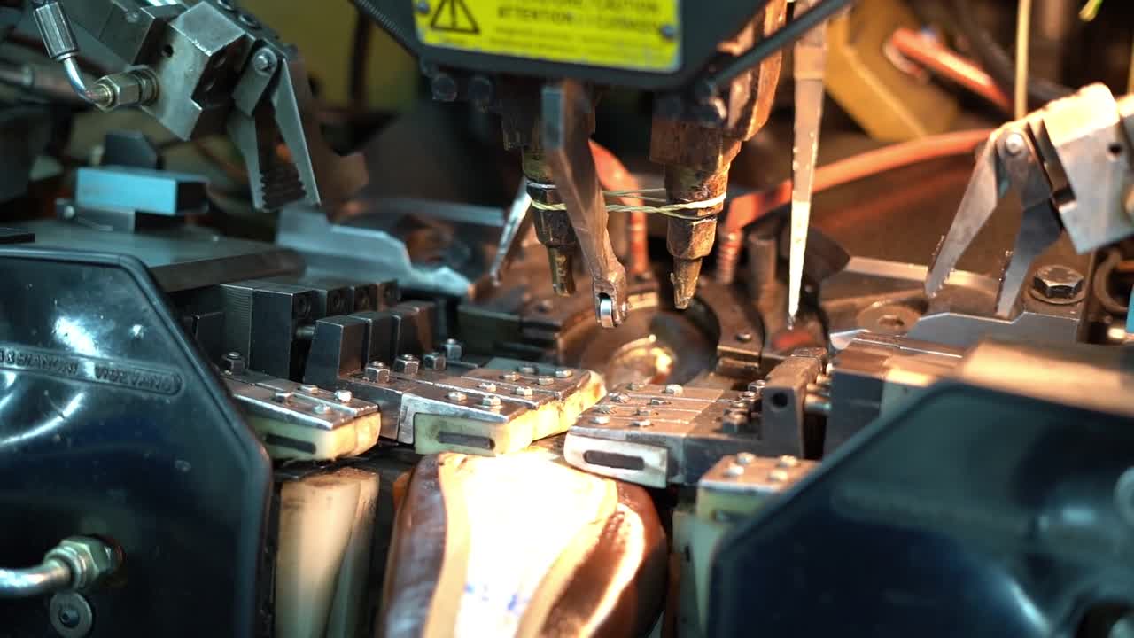 a craftsman handmade a shoe by a machine, close up shot, insert shot