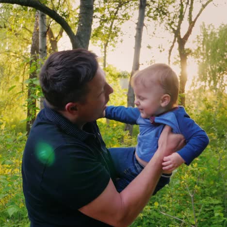 A-Young-Healthy-Father-Carries-His-Son-On-His-Shoulders