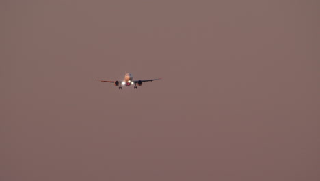 airplane landing at sunset