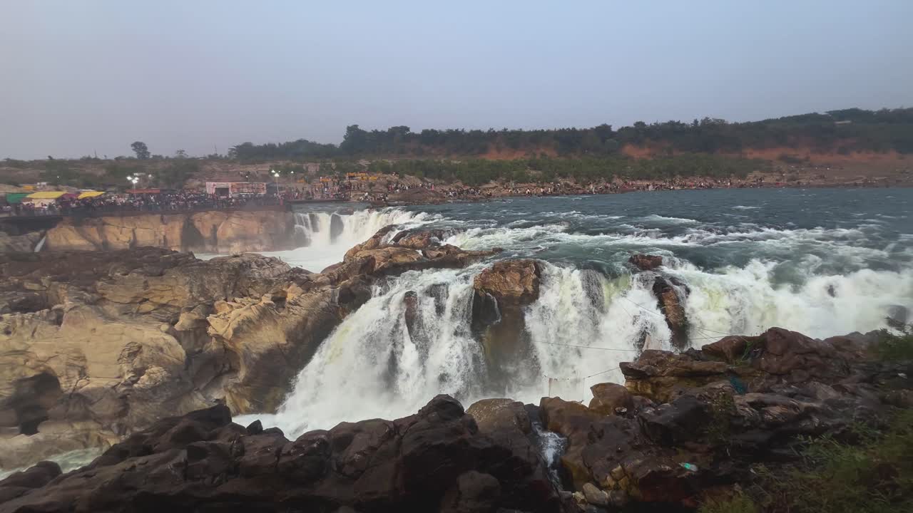 pan shot of of Dhuandhar water falls of narmada river at marble rocks of bhedaghat jabalpur in madhya pradesh india
