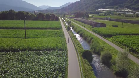 Aerial-panoramic-view-of-a-biker-with-views-of-Sugana-Valley,-Italy