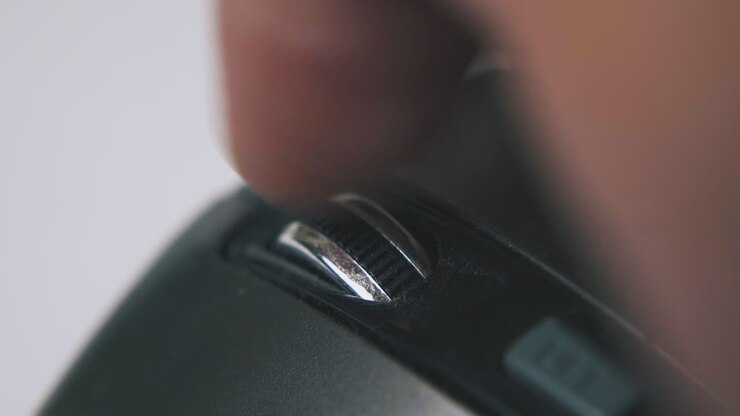 person turns wheel on computer mouse on white background