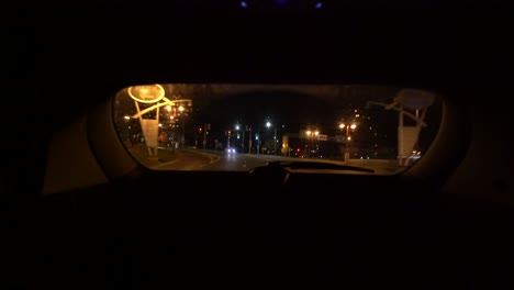 view from back rear window of suv from interior looking out, dark night drive