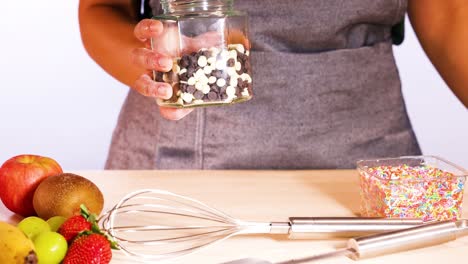 person holding jar of chocolate chips