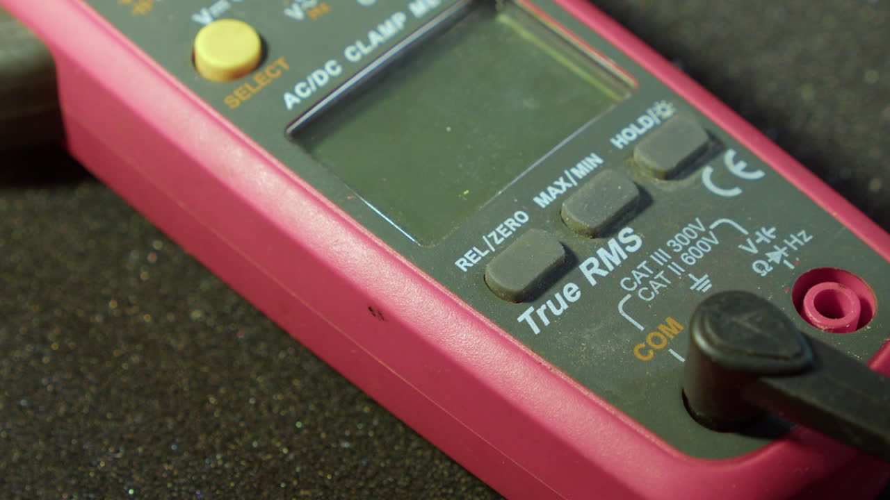 Closeup: Electrodes are connected to multimeter tool and its turned on