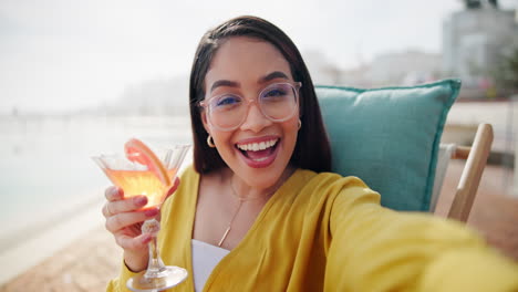 woman taking selfie with cocktail