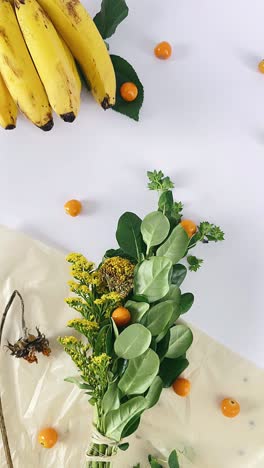 arrangement of bananas, flowers, and berries