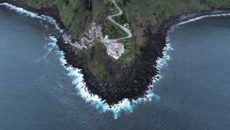 Sao-Miguel-de-Azores-lighthouse-in-green-ocean-Cliff,-aerial-fly-Portugal-travel-destination