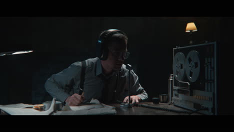 an intelligence officer listens to the wiretap recordings