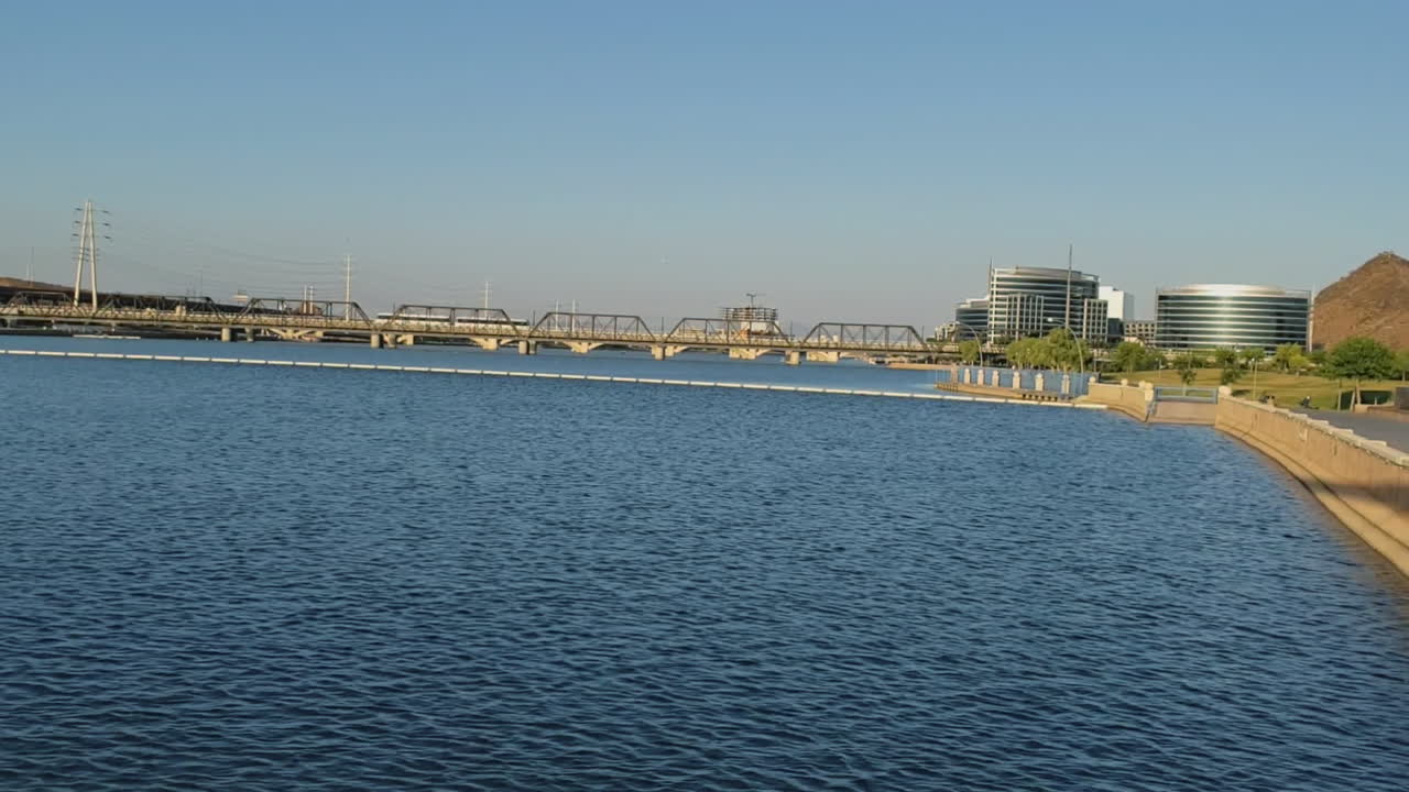 Light rail cars crossing bridge at Tempe Town Lake in Tempe, Arizona