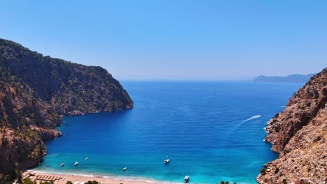 serene coastal view of a hidden bay. bright blue waters meet rugged cliffs in a tranquil bay, inviting visitors to explore the secluded beach and nature