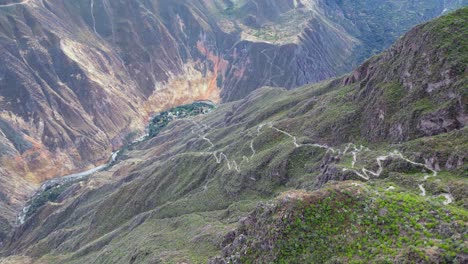 aerial view far down into deep river valley to sangalle oasis in peru