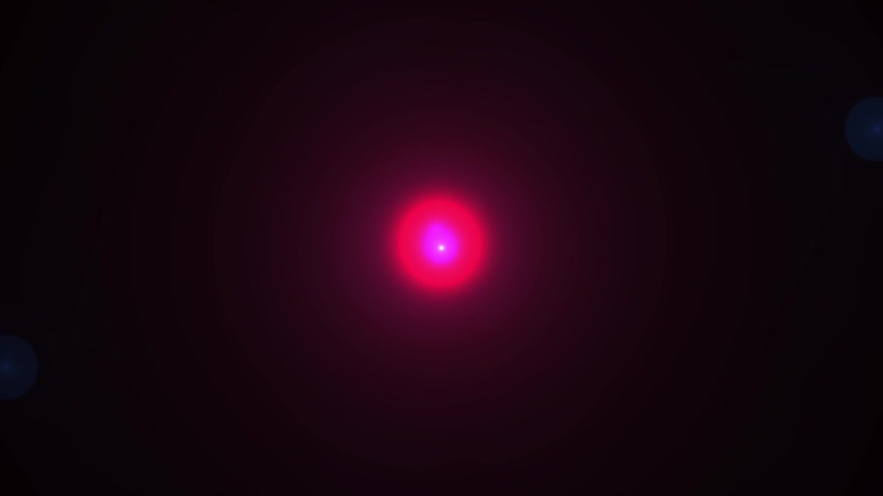 Bright Pink Light with Moving Blue Lens Flares on Black Background