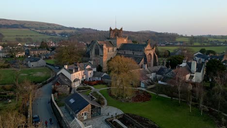 Aerial-footage-of-the-Medieval-village-of-Cartmel-in-the-English-Lake-District-it-has-a-rich-heritage,-and-varied-list-of-activities-for-visitors-and-tourists