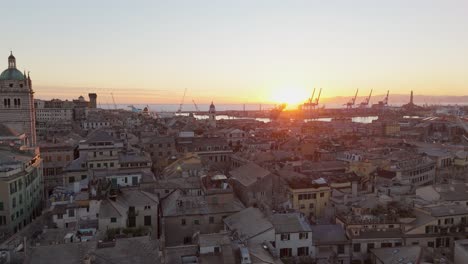 sunset over genoa's historic skyline with prominent architecture and port cranes, warm glow