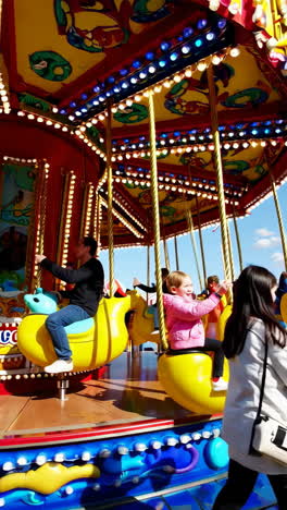 children enjoying a carousel ride at a festival