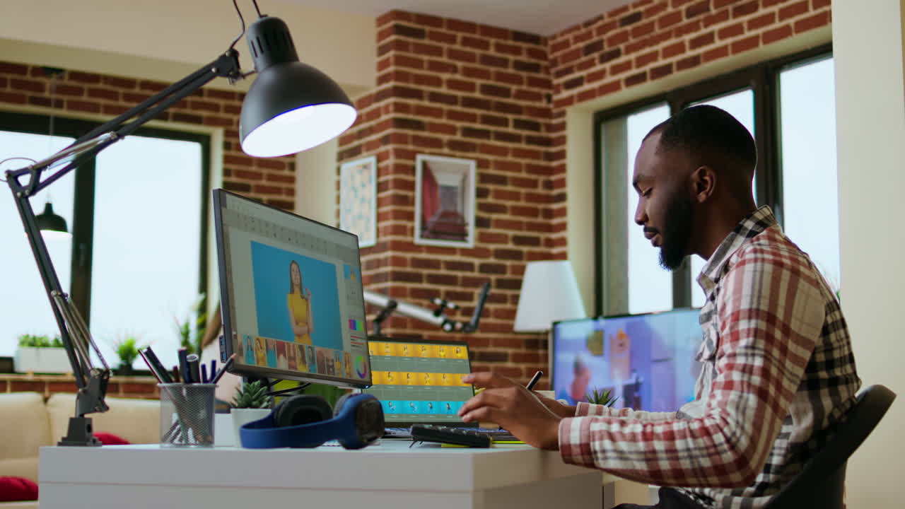 Male african american designer works with photo editing software
