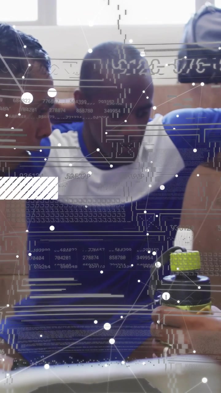 Vertical video: Seated man, peers reaching in, forming sports huddle for support with tech overlay