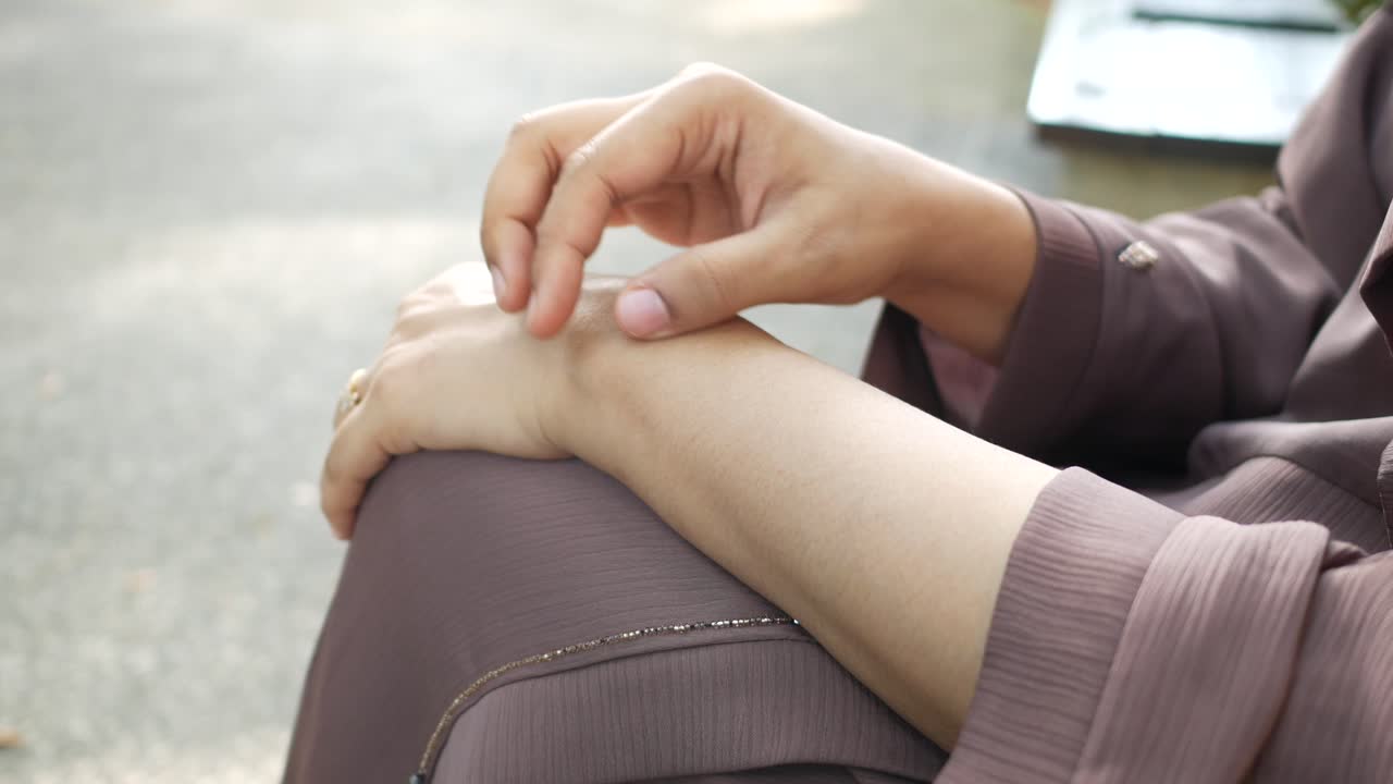 Woman checking her arm