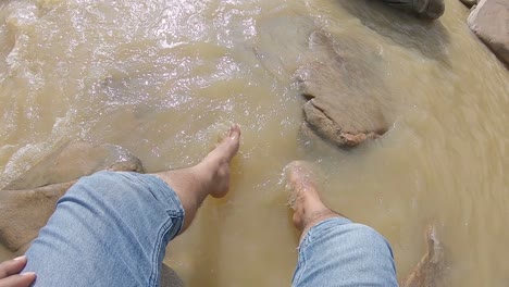 person enjoying a refreshing dip in a fast-flowing river