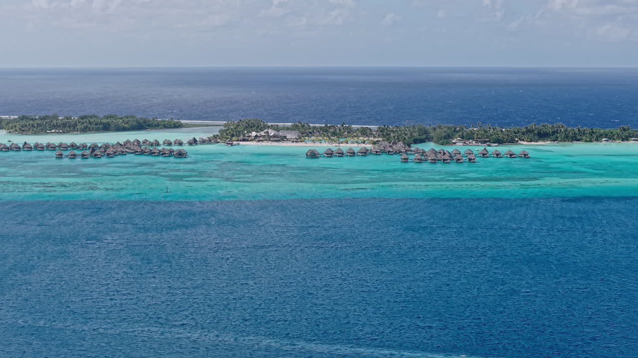 Bora Bora Island, French Polynesia. Aerial View of Overwater Villas in Lagoon, Luxury Tropical Resort and South Pacific Ocean Horizon