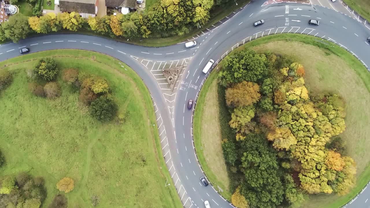 Tracking aerial view above roundabout traffic vehicles urban junction