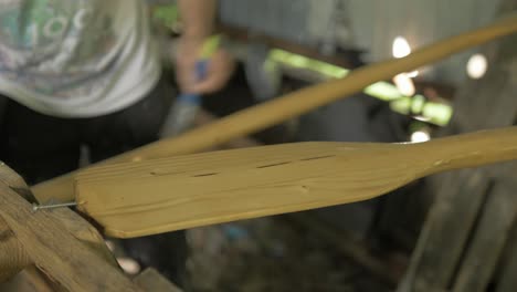 applying danish oil to handmade pine canoe paddles