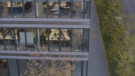 tilt-up view of a modern office building façade during twilight, showcasing urban environment and architecture