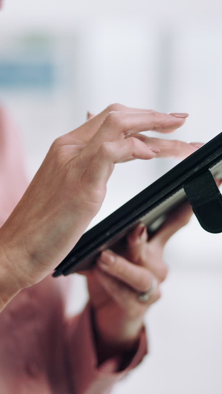 Close-up of Woman's Hands Tapping and Swiping on a Tablet