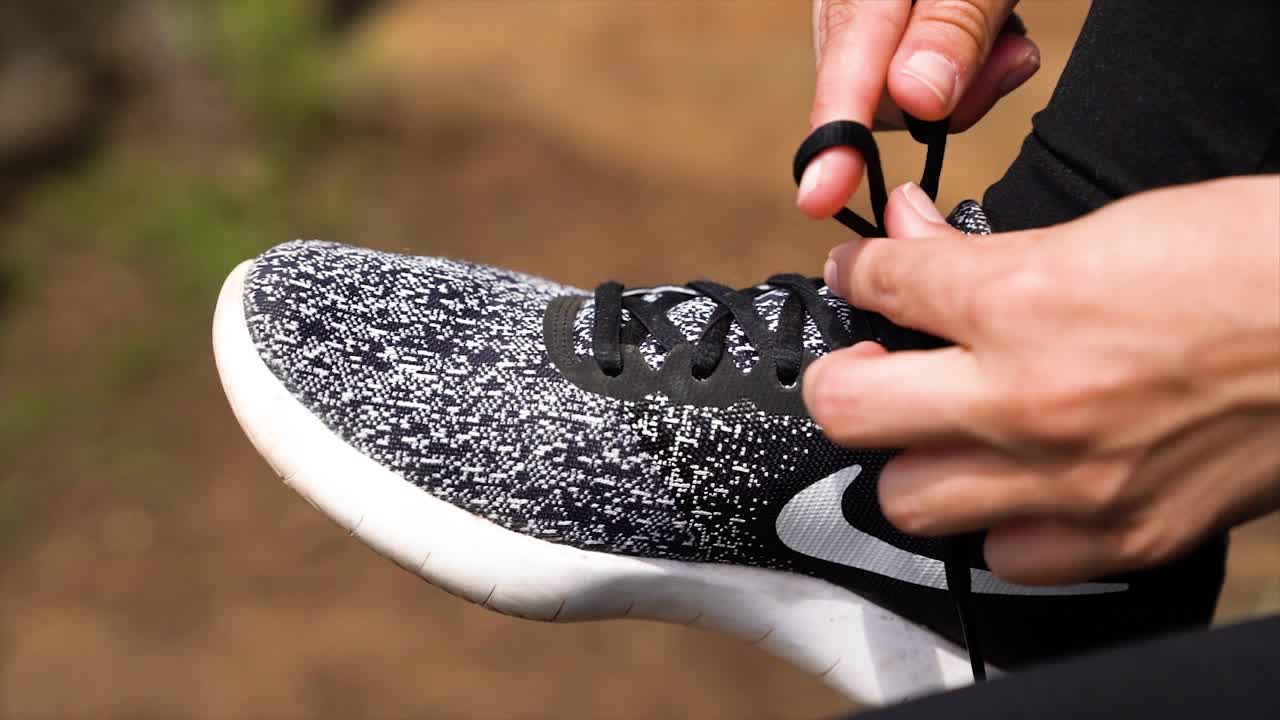 Girl tying workout shoes