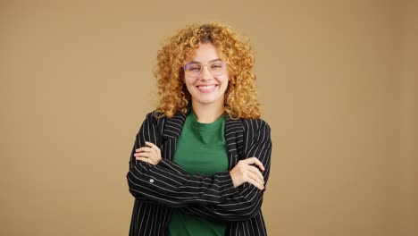 happy young woman with curly hair and glasses smiling