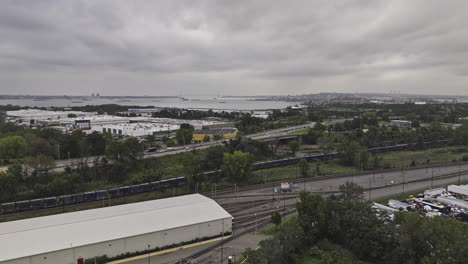 Jersey-City-New-Jersey-Aerial-v28-drone-flyover-rail-yard-capturing-Liberty-State-Park,-Upper-bay-views-and-Manhattan-cityscape-on-an-overcast-day---Shot-with-Mavic-3-Pro-Cine---September-2023