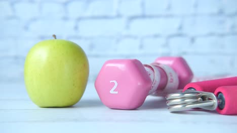 healthy lifestyle - apple and dumbbells