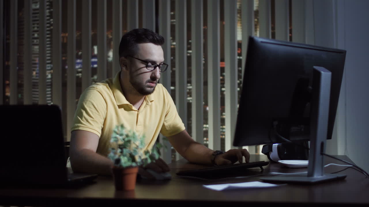 Man Working on Computer at Night