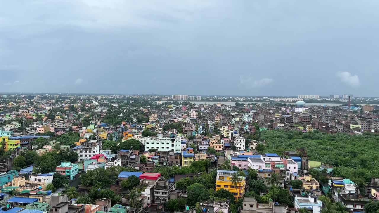 Aerial shot of Kolkata with high rise buildings and river Hoogly flowing at a distance