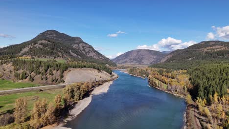 autumn majesty: scenic aerial footage of thompson river and forested mountains