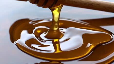 honey dripping from wooden dipper