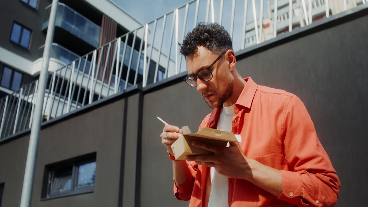 Man Eating Noodles Outside
