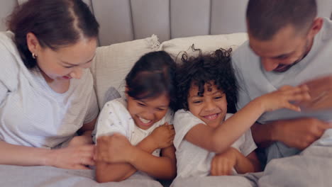 Family,-parents-and-tickling-children-in-bed