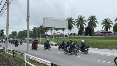 scooter and motorbike traffic in port dickson malaysia main road day time