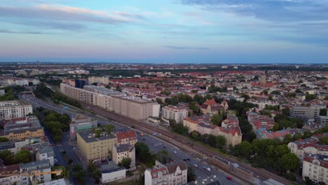 aerial view of berlin cityscape at dusk with railway tracks