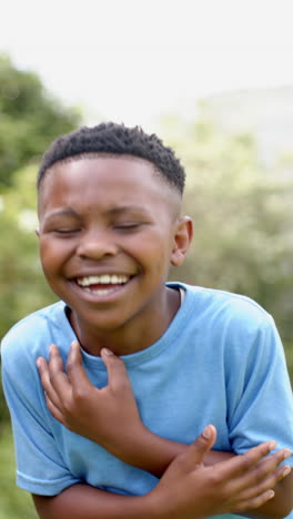 vertical video: african american boy laughing, wearing blue shirt
