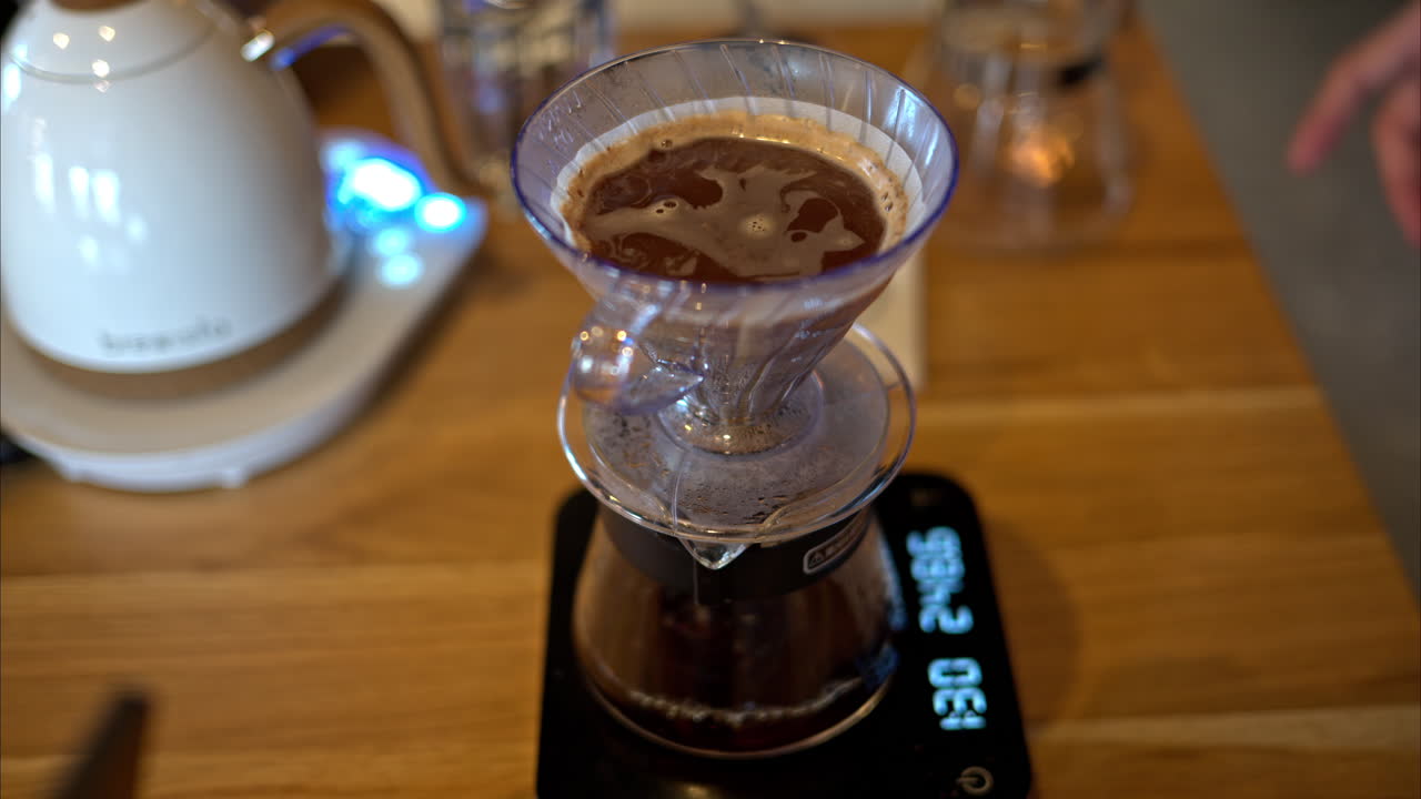 Close up of brewing pour-over drip coffee on a wooden table