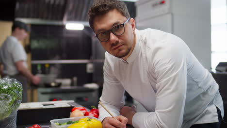 portrait of professional chef at work in restaurant kitchen