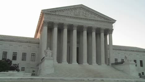 zoom back from the pillars of the supreme court building in washington dc