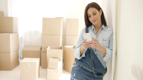 young woman doing renovations checking messages