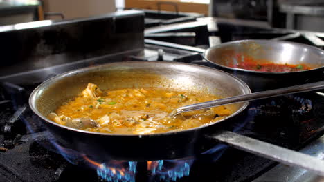 Chef-preparing-seafood-risotto-in-restaurant,-close-up,-Mediterranean